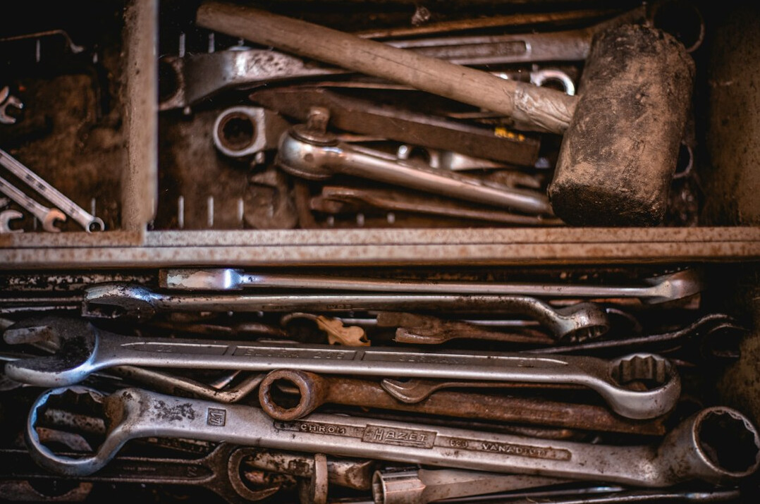 Set of hand tools laid out on a workbench